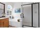 Bright bathroom with a soaking tub, shower, and decorative finishes at 1292 N Renee Ave, Gilbert, AZ 85234