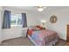 Bright bedroom with a patterned bedspread, side table and window with plenty of natural light at 1292 N Renee Ave, Gilbert, AZ 85234