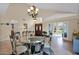 Dining room featuring a glass table, six chairs, and elegant chandelier at 1292 N Renee Ave, Gilbert, AZ 85234