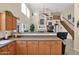 Open-concept kitchen with wooden cabinets, stainless steel appliances, and living room view at 1292 N Renee Ave, Gilbert, AZ 85234