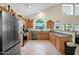 Well-lit kitchen with stainless steel appliances, wooden cabinets, and a view to the backyard at 1292 N Renee Ave, Gilbert, AZ 85234