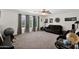 Comfortable living room featuring plush carpet, large windows, and a ceiling fan at 1292 N Renee Ave, Gilbert, AZ 85234