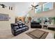 Open living room with vaulted ceilings, two leather sofas, and view to kitchen at 1292 N Renee Ave, Gilbert, AZ 85234