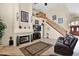 Cozy living room with a fireplace, a large TV, and access to the staircase at 1292 N Renee Ave, Gilbert, AZ 85234