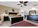 This main bedroom includes tile flooring, ceiling fan, and access to the main bathroom at 1292 N Renee Ave, Gilbert, AZ 85234