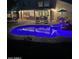 Nighttime view of a backyard pool with patio seating and colorful inflatables at 1292 N Renee Ave, Gilbert, AZ 85234