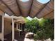 Inviting backyard space with a shady pergola and lush, colorful rose bushes at 13608 N 19Th Pl, Phoenix, AZ 85022