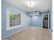 Well-lit bedroom with tile floors, large windows and access to the rest of the home at 13608 N 19Th Pl, Phoenix, AZ 85022