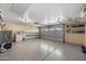 Spacious garage with epoxy floors, ample shelving, and a pristine utility sink at 13608 N 19Th Pl, Phoenix, AZ 85022