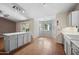 Bright eat-in kitchen with tile floors, breakfast bar, and white cabinets at 13608 N 19Th Pl, Phoenix, AZ 85022