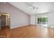 Spacious living room boasts neutral decor, a ceiling fan, and a sliding glass door at 13608 N 19Th Pl, Phoenix, AZ 85022