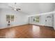 Bright living room features neutral walls, a ceiling fan, and tile flooring at 13608 N 19Th Pl, Phoenix, AZ 85022