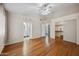 Spacious main bedroom with wood floors, ceiling fan, and ensuite bathroom access at 13608 N 19Th Pl, Phoenix, AZ 85022