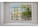 A large window with views of lush landscaping from an interior room at 13608 N 19Th Pl, Phoenix, AZ 85022