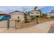 Inviting exterior features a brick fence, desert landscaping, and a well-maintained lawn, enhancing the home's curb appeal at 14001 N 34Th Dr, Phoenix, AZ 85053