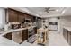 Efficient kitchen featuring stainless steel appliances, dark cabinets, and a portable kitchen island with tile backsplash at 14001 N 34Th Dr, Phoenix, AZ 85053