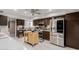 Modern kitchen boasting stainless steel appliances, rich cabinetry, tile floors, and a functional kitchen island at 14001 N 34Th Dr, Phoenix, AZ 85053