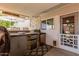 Outdoor kitchen has built-in bar, mini fridge, prep area, and access to the main house at 14001 N 34Th Dr, Phoenix, AZ 85053