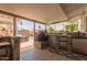 Outdoor kitchen features stainless steel appliances, stone accents, and a view of the backyard pool at 14001 N 34Th Dr, Phoenix, AZ 85053
