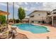 Backyard oasis featuring a sparkling pool with stone features and patio seating at 14001 N 34Th Dr, Phoenix, AZ 85053