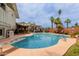 Backyard pool with diving board, patio furniture, and lush palm trees for a private outdoor oasis at 14001 N 34Th Dr, Phoenix, AZ 85053