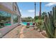 The backyard features desert landscaping, a sparkling pool, and a view of the neighboring homes at 15753 W Kino Dr, Surprise, AZ 85374