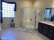 Bright bathroom showcasing a glass-enclosed shower, vanity, and tiled floors at 15753 W Kino Dr, Surprise, AZ 85374