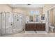 Spacious bathroom featuring a glass shower enclosure, double sink vanity, and ample natural light at 15753 W Kino Dr, Surprise, AZ 85374