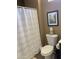 Functional bathroom with a toilet, shower curtain, and coordinated decor at 15753 W Kino Dr, Surprise, AZ 85374