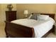 Comfortable bedroom with a queen-size bed, dresser, and bedside table at 15753 W Kino Dr, Surprise, AZ 85374
