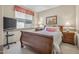 Comfortable bedroom with a sleigh bed, side tables, soft lighting, and natural light creating a serene atmosphere at 15753 W Kino Dr, Surprise, AZ 85374
