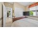 Bedroom showcasing a large window, TV, and closet with sliding doors, offering ample space and storage at 15753 W Kino Dr, Surprise, AZ 85374