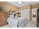 Cozy bedroom with neutral walls, a comfortable bed, and a closet with sliding doors at 15753 W Kino Dr, Surprise, AZ 85374