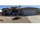 Charming single-story home with well-maintained landscaping and a two-car garage at 15753 W Kino Dr, Surprise, AZ 85374