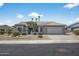 Charming single-story home featuring desert landscaping, a tile roof, and an attached two-car garage at 15753 W Kino Dr, Surprise, AZ 85374