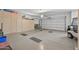 Spacious two car garage with ample cabinet storage and a golf cart at 15753 W Kino Dr, Surprise, AZ 85374