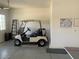 Spacious garage featuring a golf cart, ladder, and additional storage for convenience at 15753 W Kino Dr, Surprise, AZ 85374
