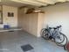 Spacious garage with ample storage cabinets and room for bicycles and other items at 15753 W Kino Dr, Surprise, AZ 85374