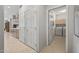 Hallway view to kitchen and laundry room with neutral tile flooring and neutral colored walls at 15753 W Kino Dr, Surprise, AZ 85374