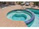 Inviting hot tub features sparkling blue tiles and is surrounded by ample space for relaxation and entertaining at 15753 W Kino Dr, Surprise, AZ 85374