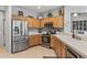 Well-appointed kitchen with stainless steel appliances and a breakfast bar at 15753 W Kino Dr, Surprise, AZ 85374