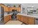 Modern kitchen with stainless steel appliances, oak cabinets and white countertops that provide ample room for meal prep and cooking at 15753 W Kino Dr, Surprise, AZ 85374