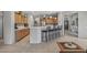 Kitchen with breakfast bar, tile floors, light wood cabinets, and access to the living room at 15753 W Kino Dr, Surprise, AZ 85374