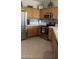 Well-lit kitchen featuring wooden cabinets, stainless steel appliances, and white countertops at 15753 W Kino Dr, Surprise, AZ 85374