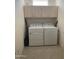 Efficient laundry room with white washer and dryer, plus ample storage cabinetry at 15753 W Kino Dr, Surprise, AZ 85374