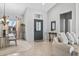 Inviting living room featuring neutral tones, front door, stylish decor, and tiled flooring at 15753 W Kino Dr, Surprise, AZ 85374