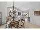 Open-concept living room showcasing chandelier, dining area, and neutral-toned furnishings at 15753 W Kino Dr, Surprise, AZ 85374