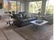 Spacious living room with comfortable leather seating and multiple tables at 15753 W Kino Dr, Surprise, AZ 85374