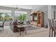 Cozy living room featuring large windows with natural light, comfortable seating and a ceiling fan for added comfort at 15753 W Kino Dr, Surprise, AZ 85374