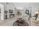 Cozy living room with tile floors, chandelier, comfortable seating, and stylish decor at 15753 W Kino Dr, Surprise, AZ 85374